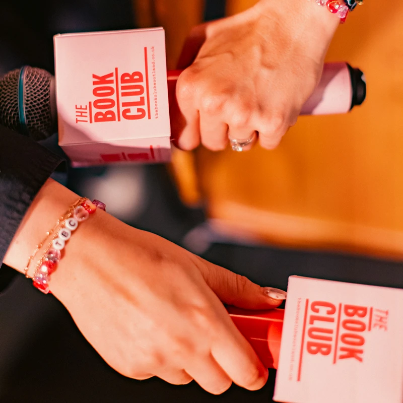 Close-up of branded microphones used at a Book Club Scotland event.
